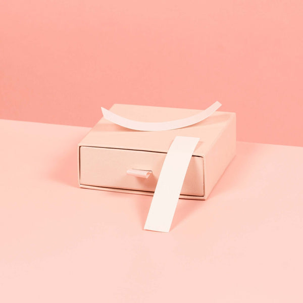 Double-sided tape for clothing on the pink box with Brelese logo