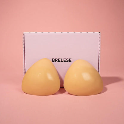 Double-stick push-up bra inserts in Nude colour next to the pink Brelese box.